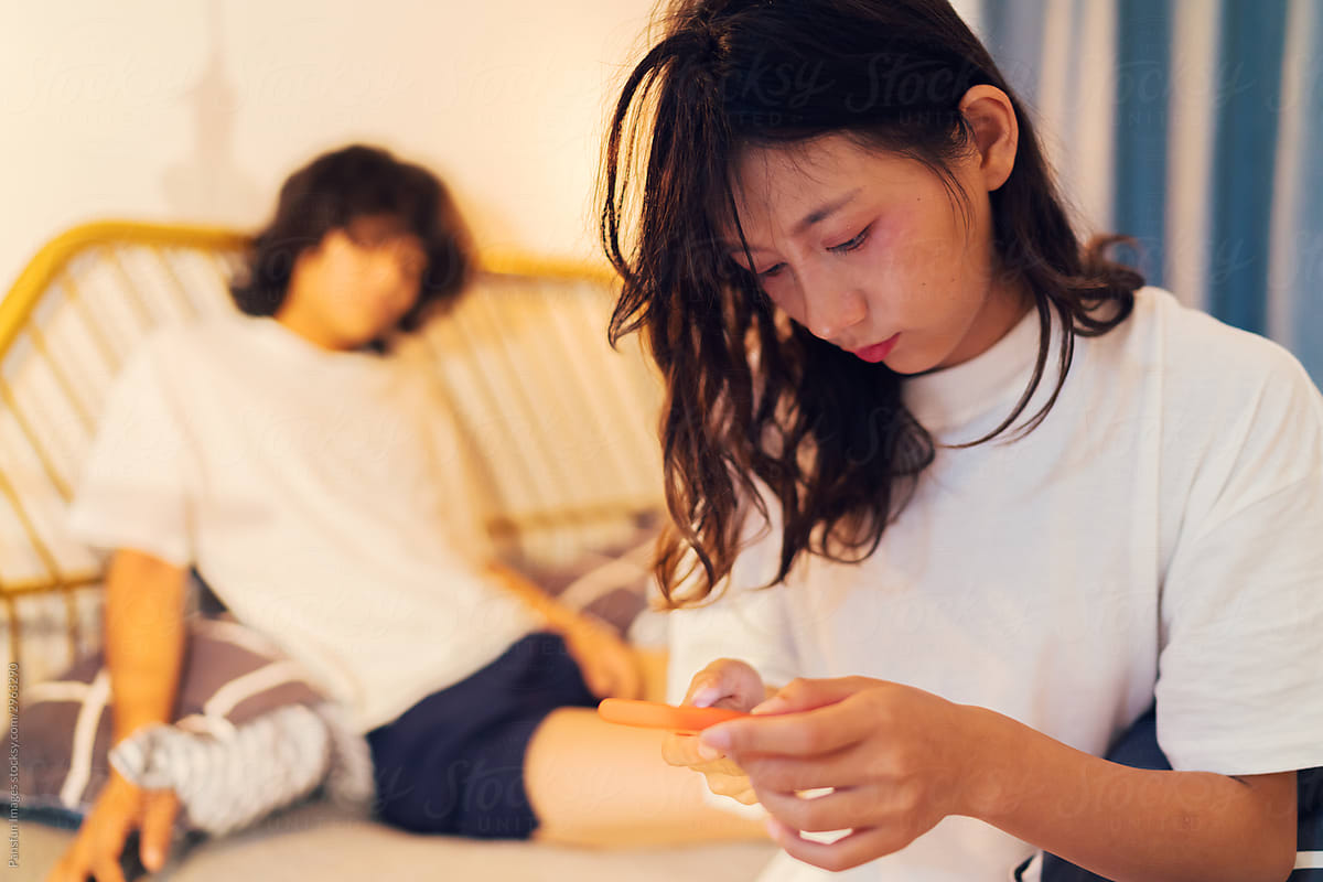 life of young couple using cell phone on bed