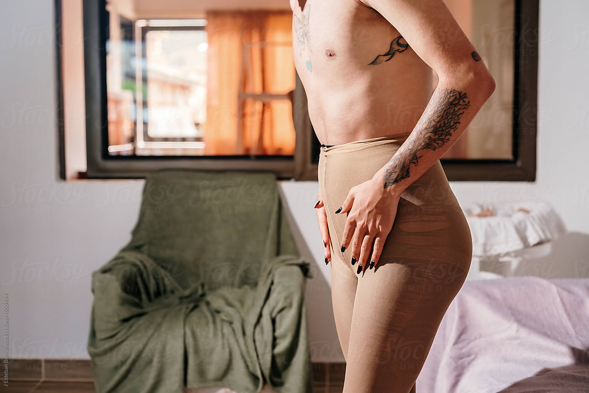 Shirtless and tattooed man with veiled stockings
