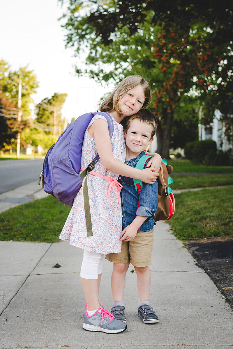 Siblings Hugging On The First Day Of School Del Colaborador De Stocksy Lindsay Crandall