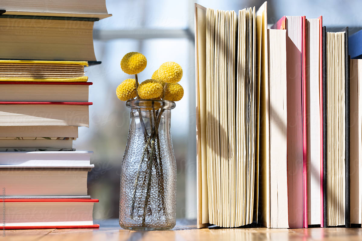 Books lined up on flowers