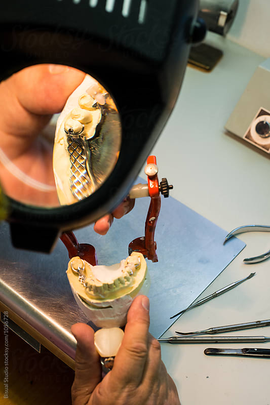 Dental Technician making handmade dental prosthesis in a work shop