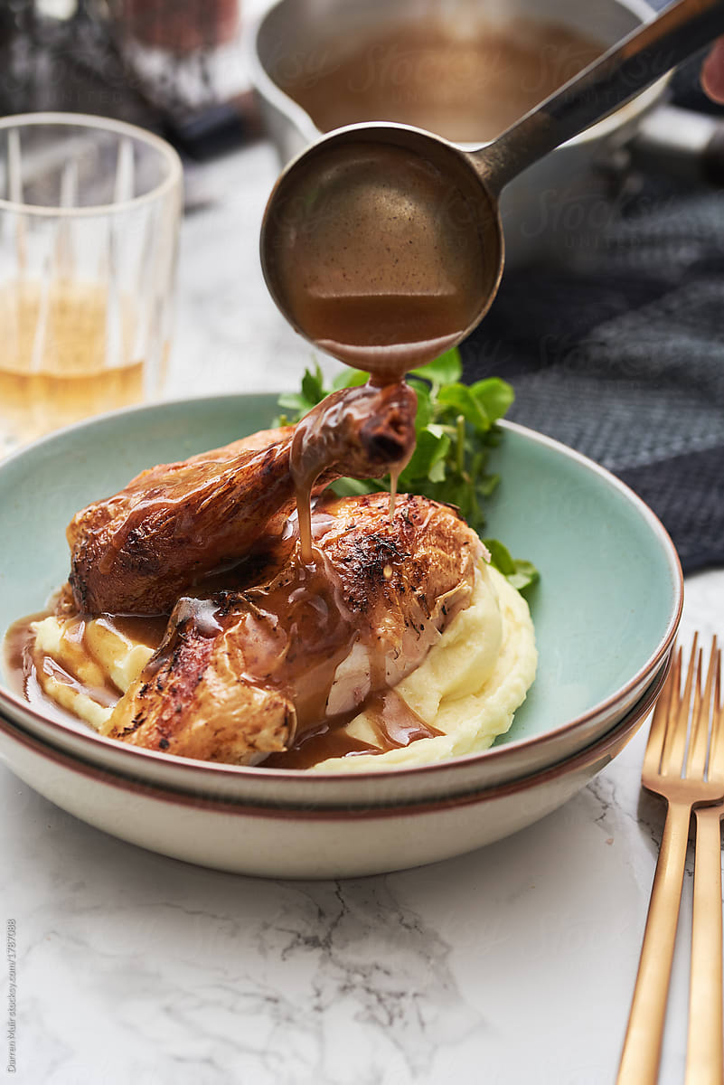 Roast chicken with mash potato and gravy.