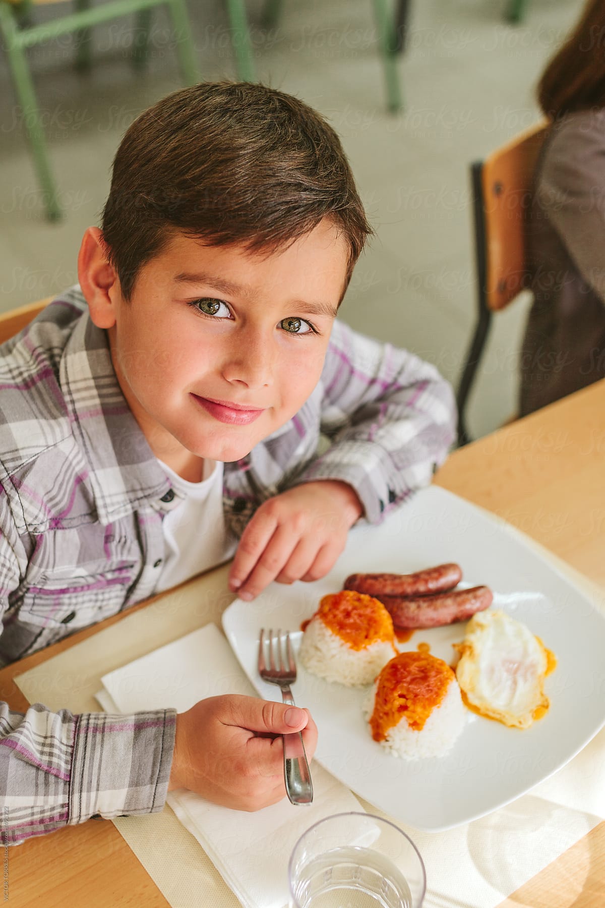 Kindergarten Kids Eating At School Canteen by Stocksy Contributor VICTOR  TORRES - Stocksy