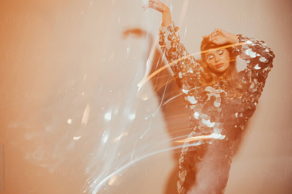 Long exposure fashion portrait of woman in sequins dress