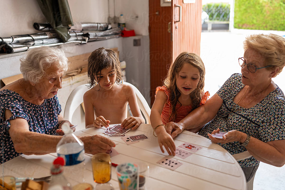 Great grandmas playing cards with the kids