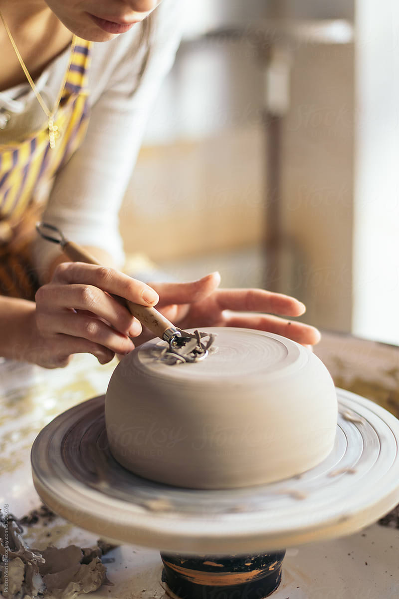 Woman Shaping Clay Edges On Pottery Wheel