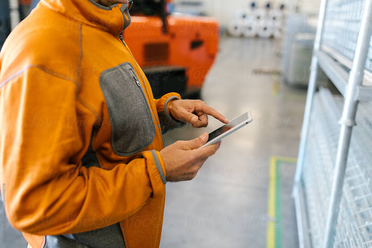 Anonymous Man Using Tablet In A Factory