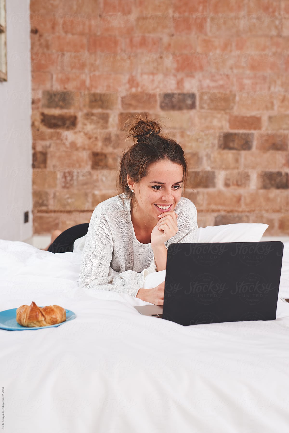 Girl watching laptop on bed