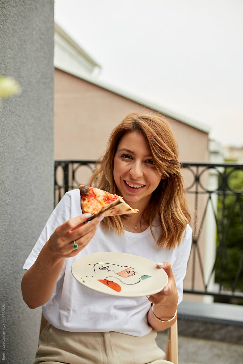 Woman enjoys eating pizza