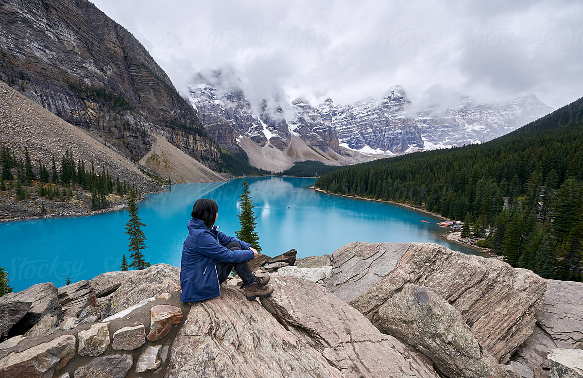 Woman Enjoying The Snowy Landscape And The Beauty Turquoise Moraine