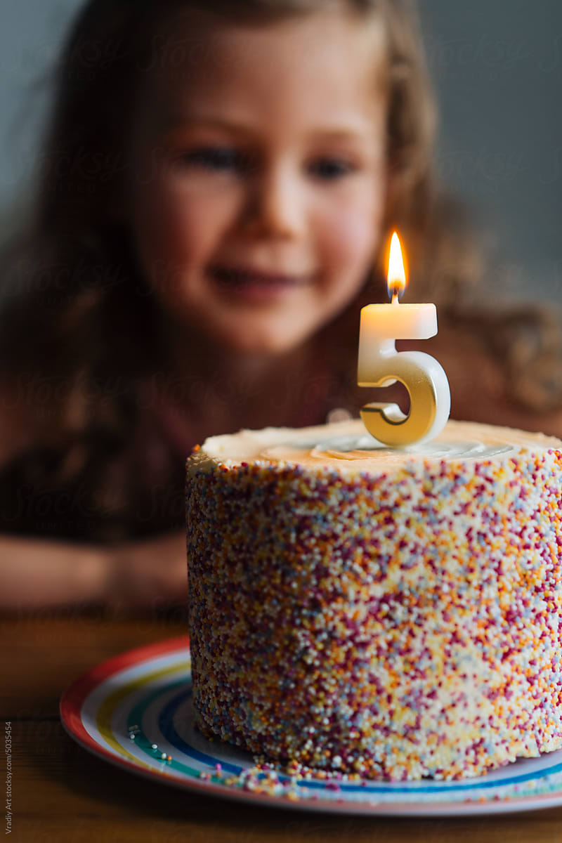Little girl with birthday cake
