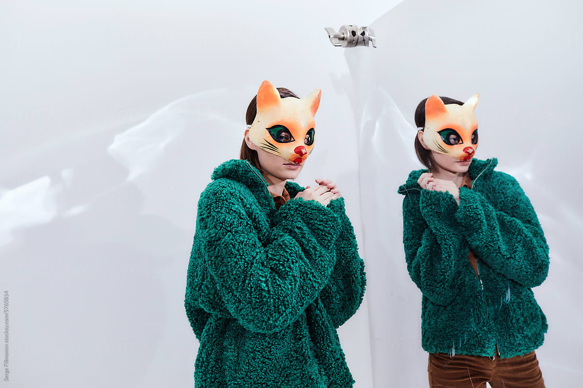 Surreal fashion portrait with woman in mask