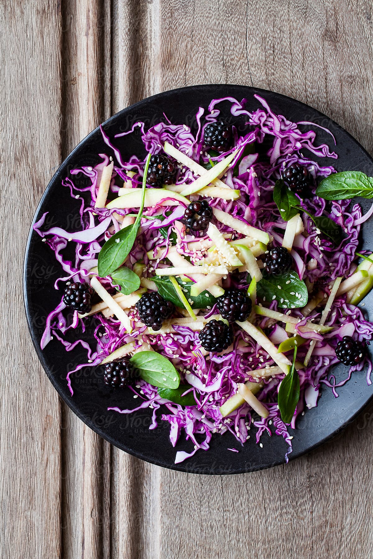 Blackberry coleslaw with finely shredded cabbage, apple and spinach