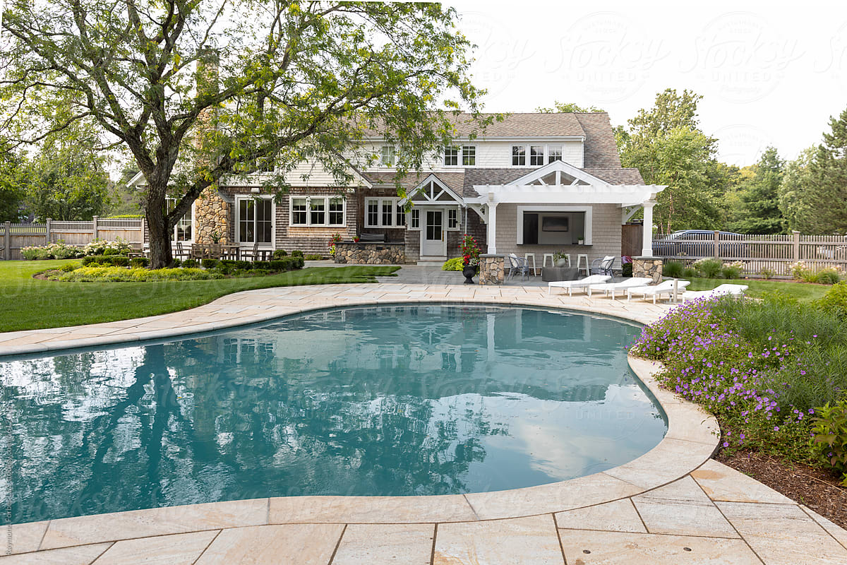 Residential luxury Home outdoor terrace patio and blue swimming pool