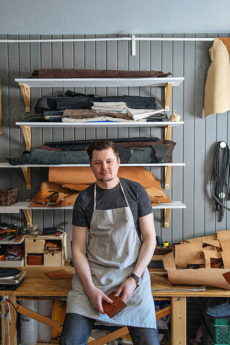 portrait of a man in a leather workshop