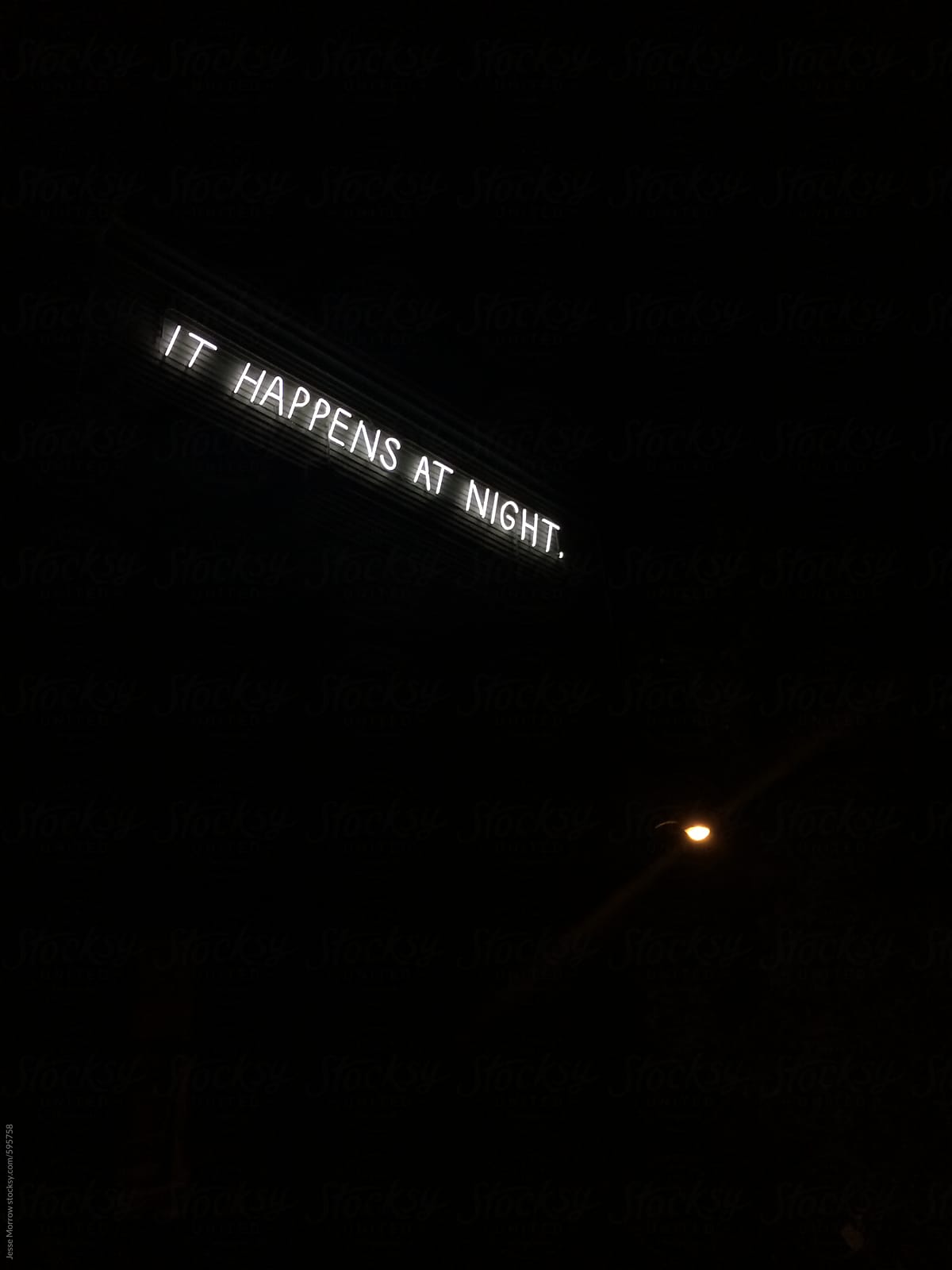 it happens at night neon sign in black dark