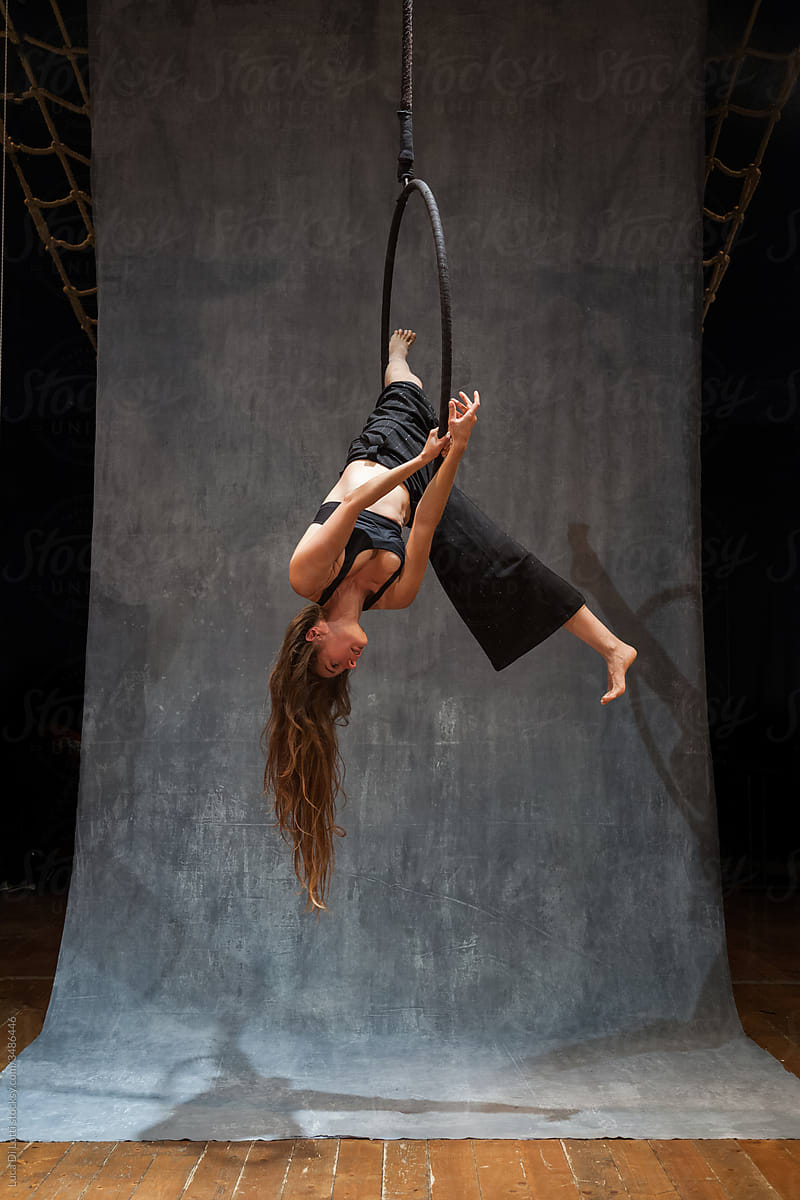Aerial artist suspended to a Lyra or Aerial hoop 7