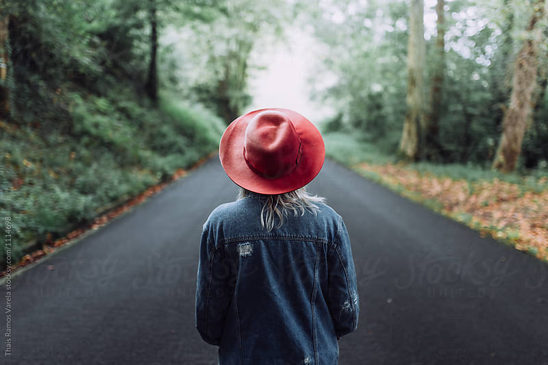 woman wearing red hat in the middle of the road