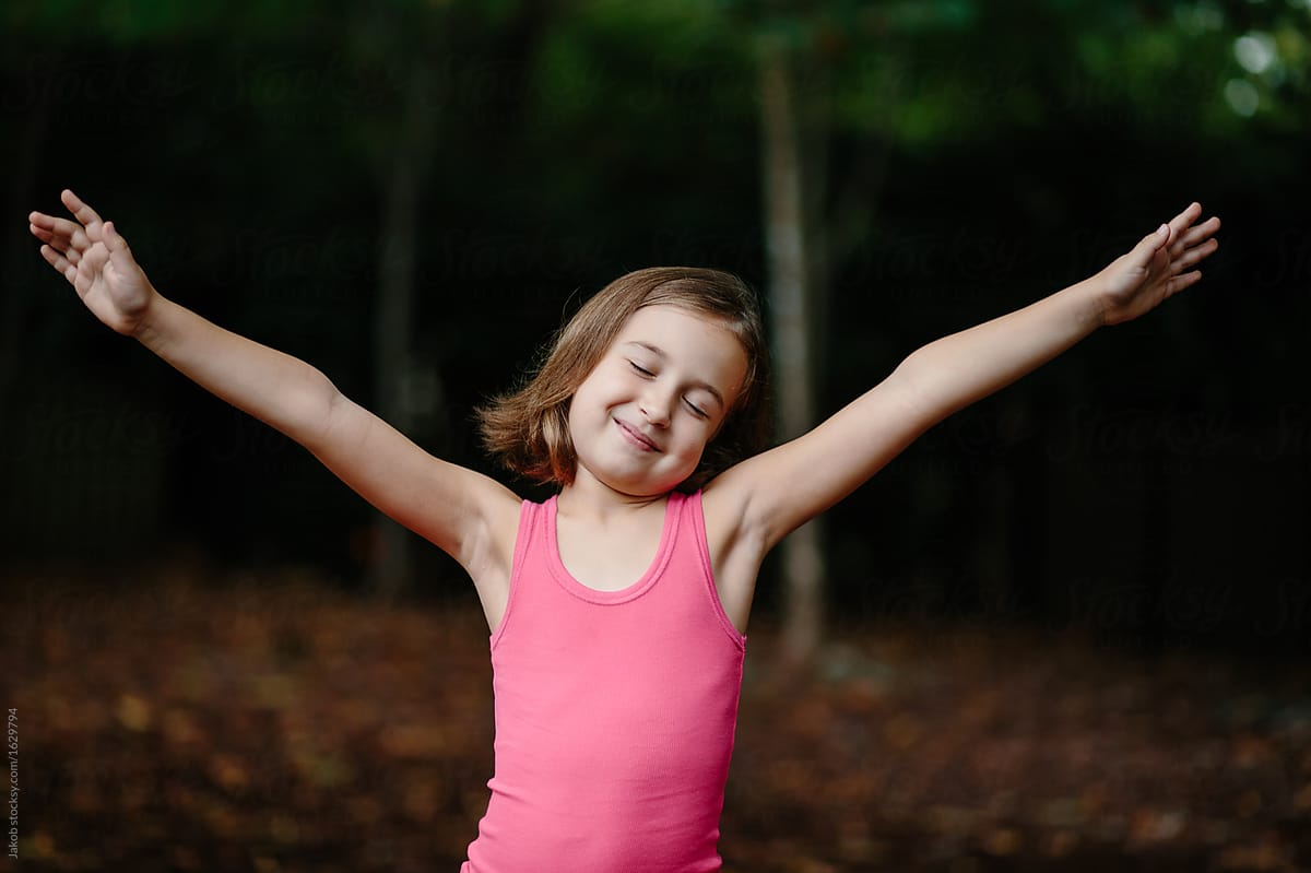 Cute Young Girl In Tank Top Stretching Out Her Arms With Her Eye Closed by  Stocksy Contributor Jakob Lagerstedt - Stocksy