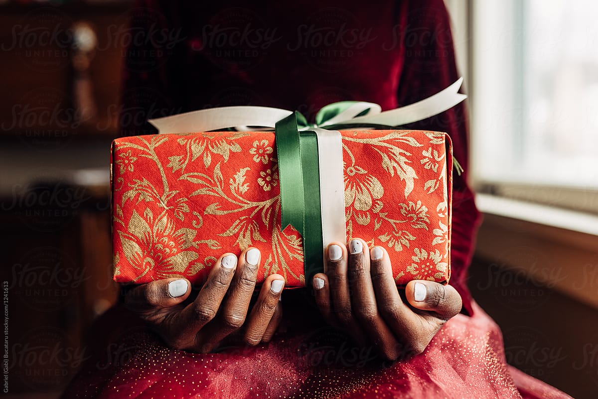Christmas gift in the hands of a black girl