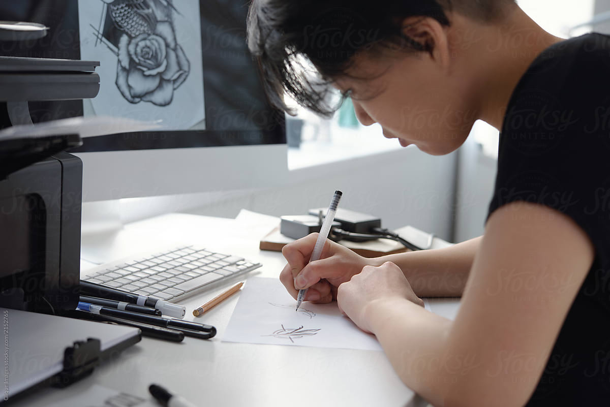 Female tattoo artist making sketches