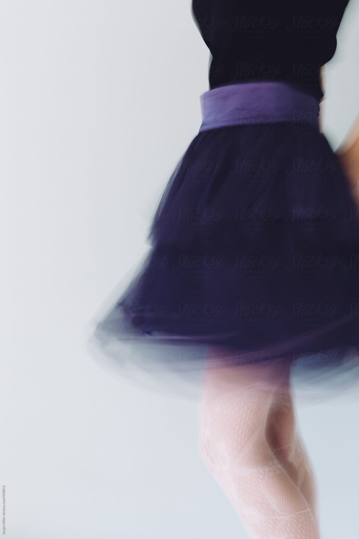 Feminine movement shot of woman wearing purple tulle skirt