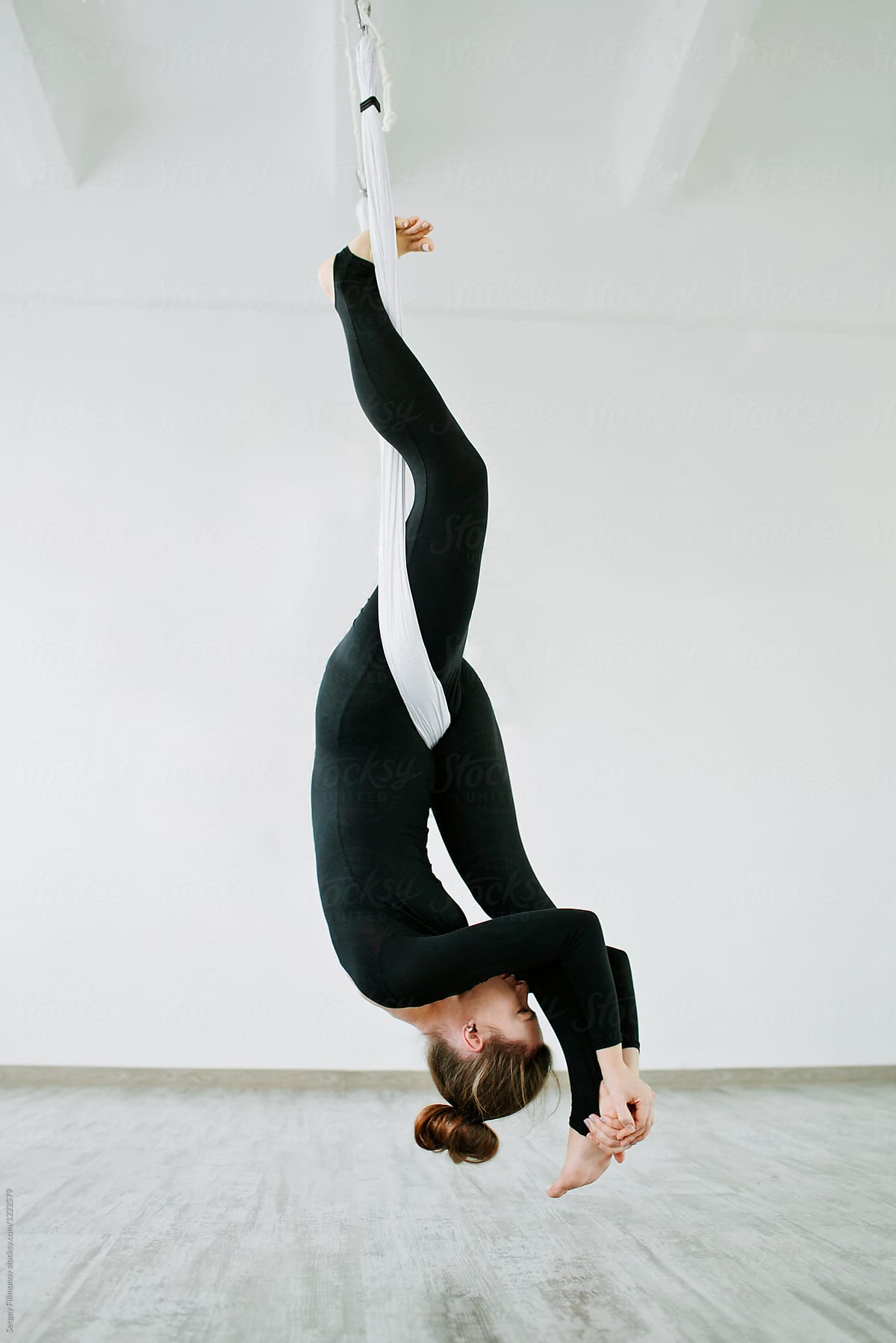 Young Woman Performing Antigravity Yoga Exercise By Stocksy Contributor Serge Filimonov 3581