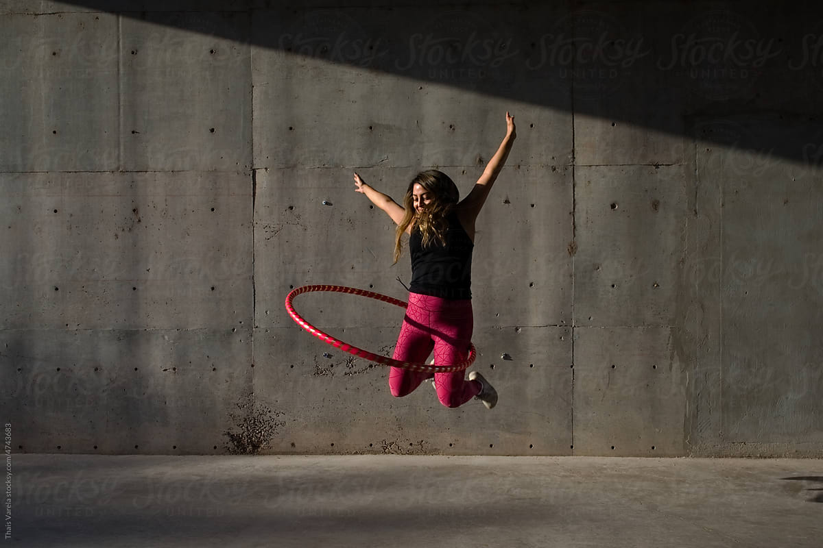woman jumps with her hula hoop