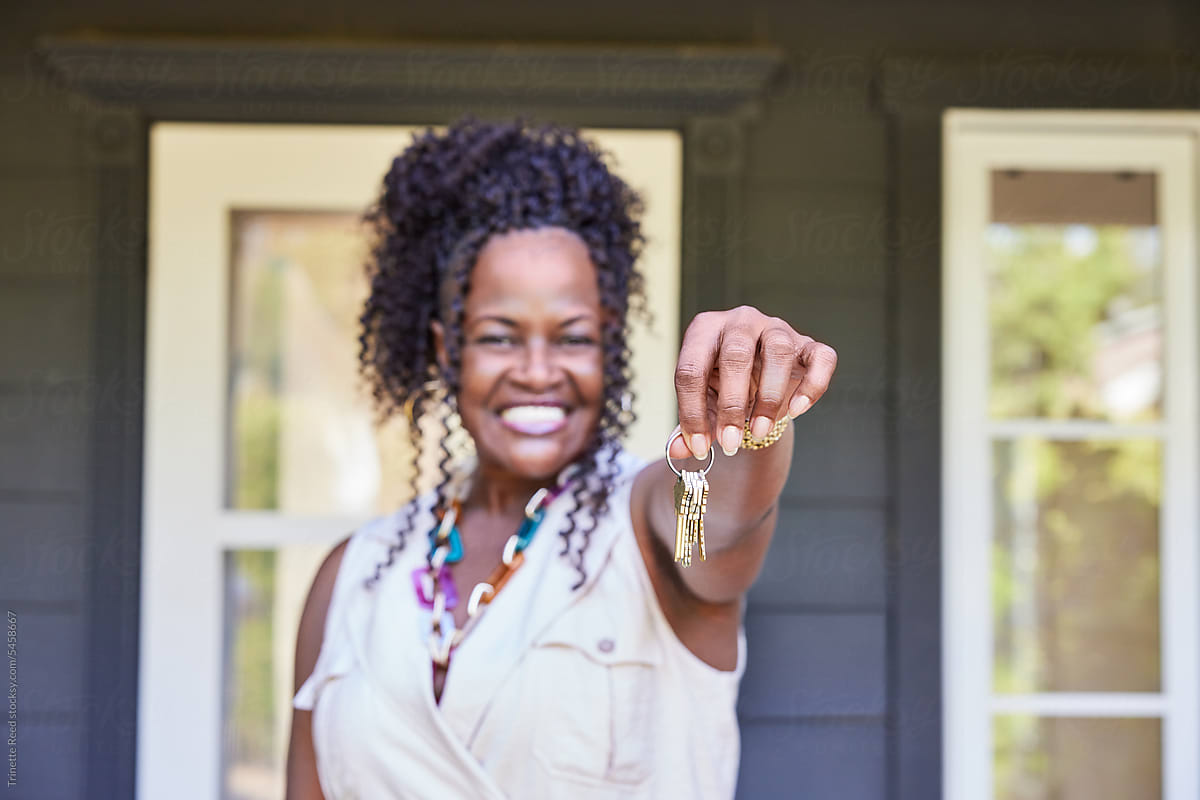 Close-up of excited mature Black woman new home owner holding keys