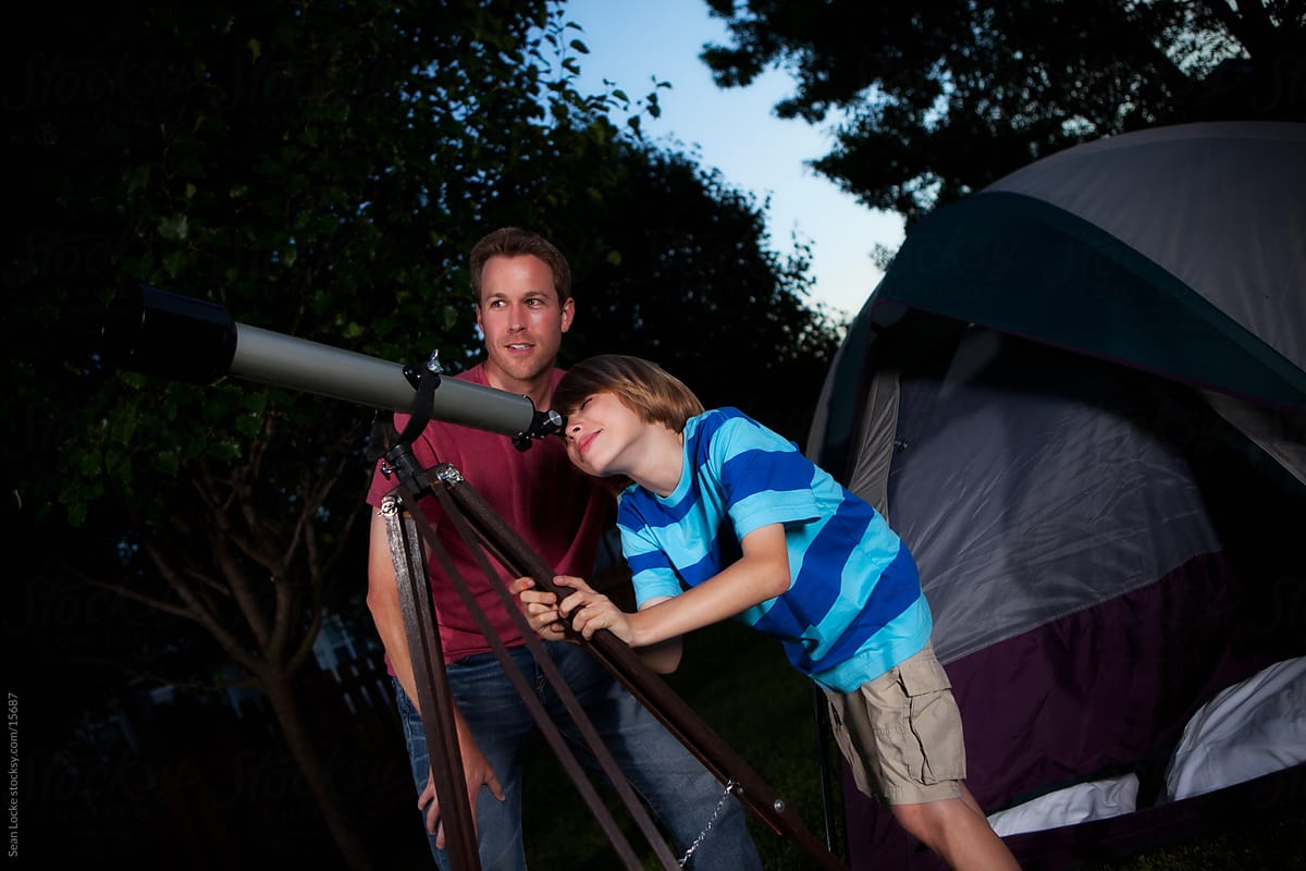 Camping: Father and Son Use Telescope