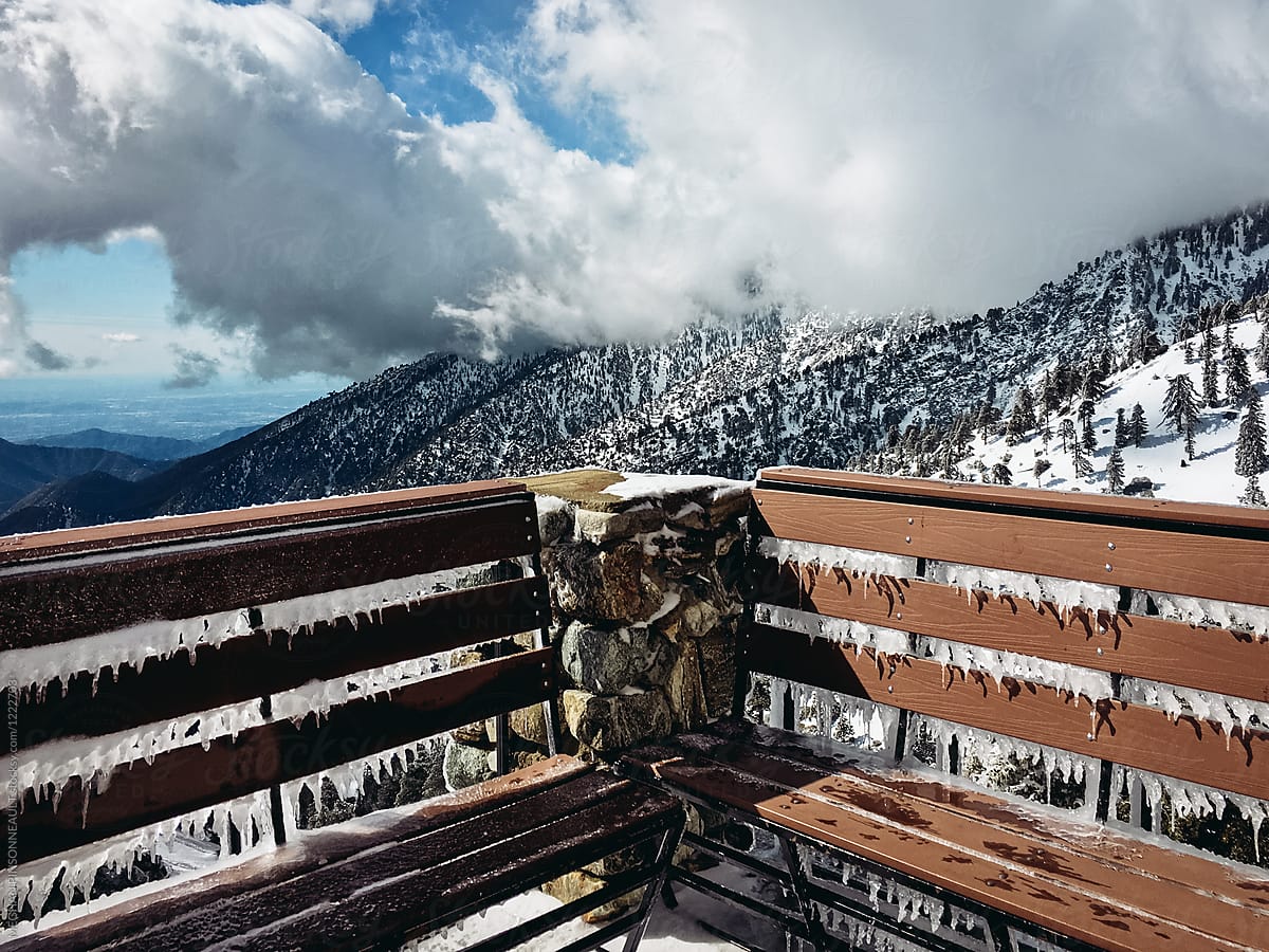 Icy Bench with Beautiful Snowy Mountain View