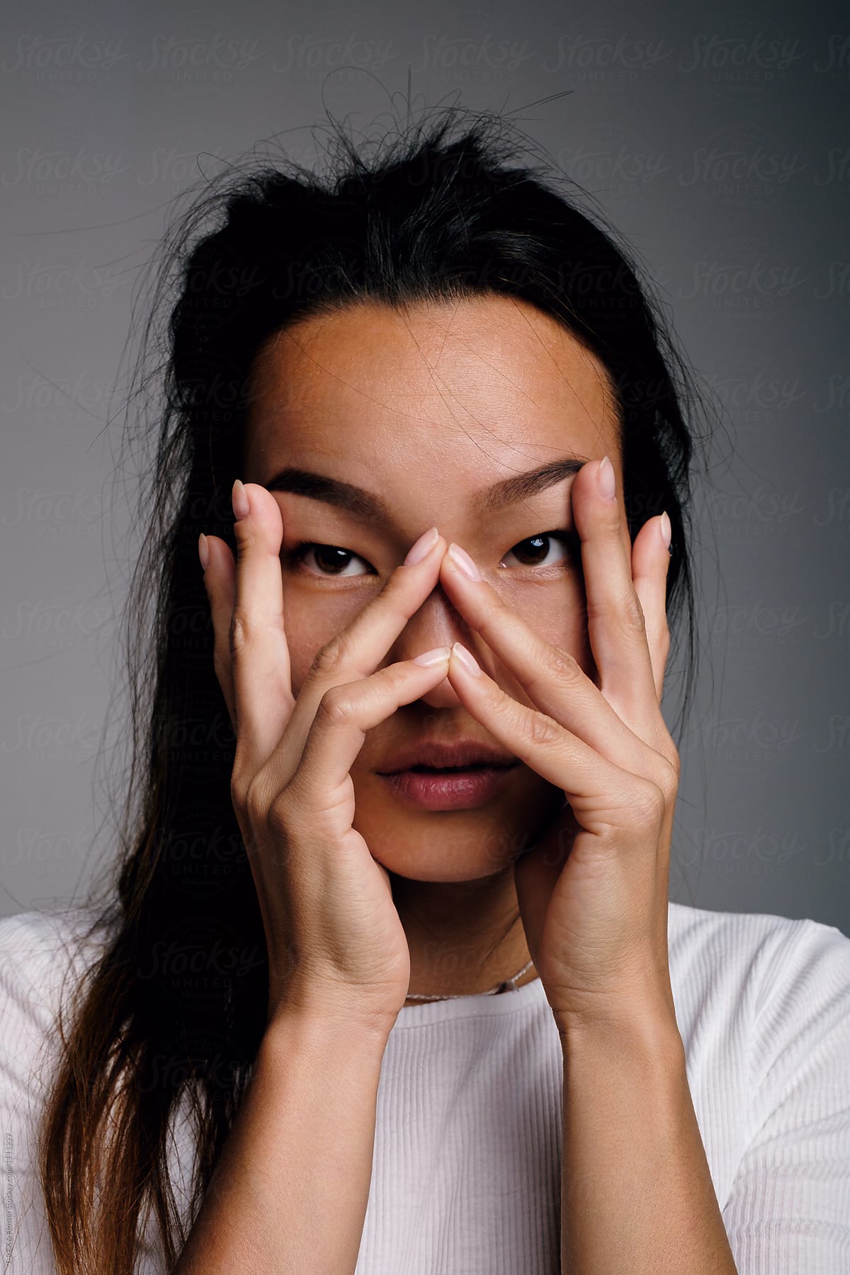 Asian model with hands on face