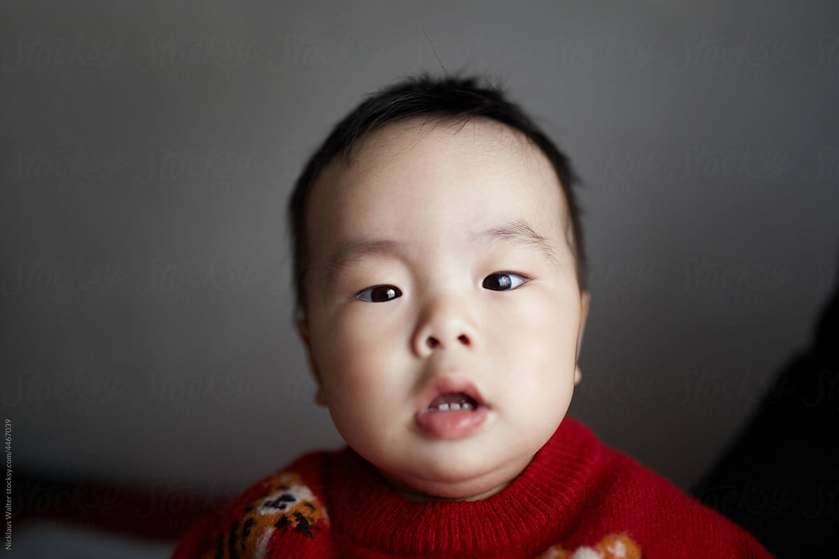 Closeup portrait of a male Chinese infant at home.