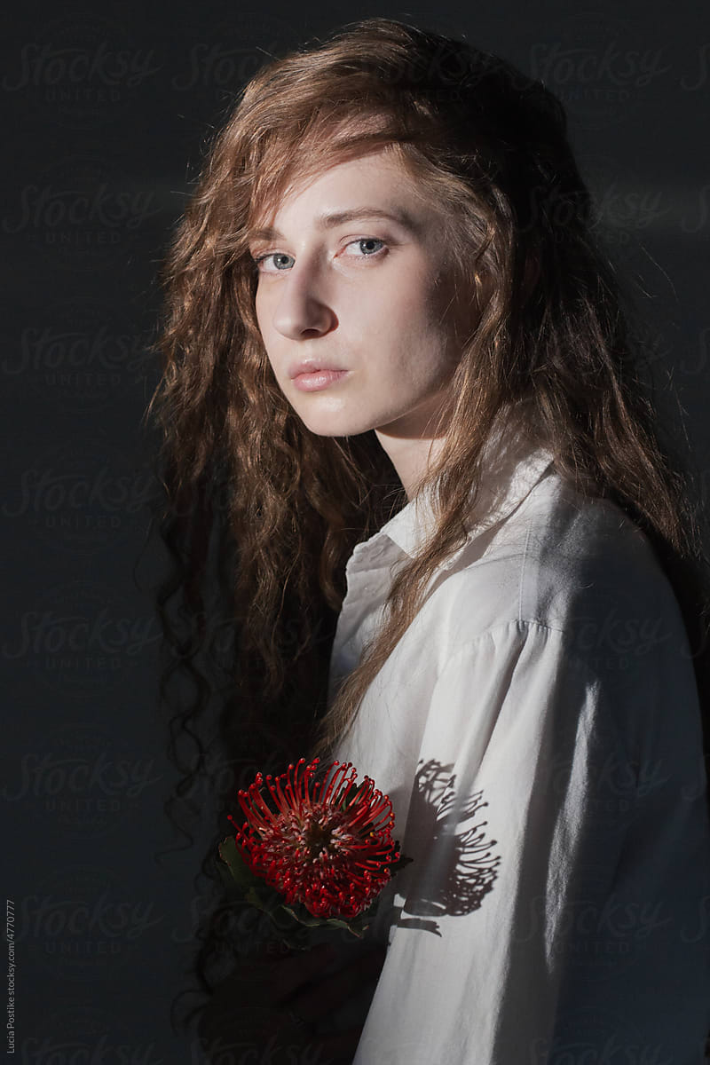 Long haired woman with red flower