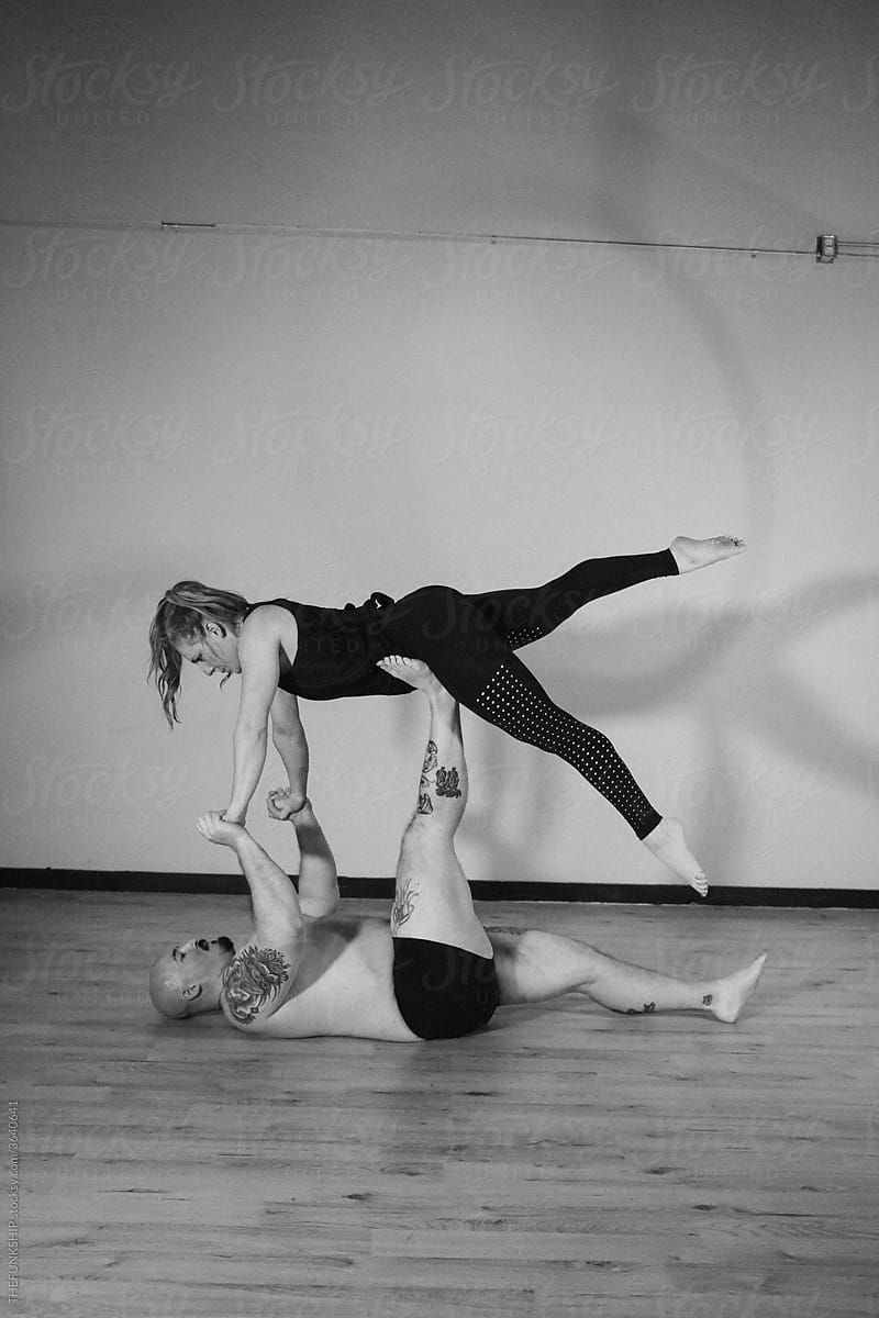 Fit Couple Doing Acro Yoga
