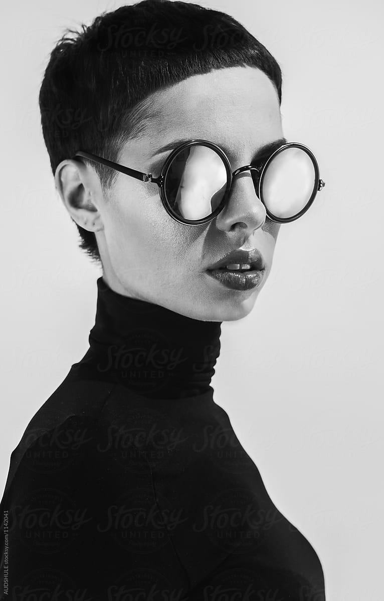 Black and white conceptual portrait of female model with sunglases.