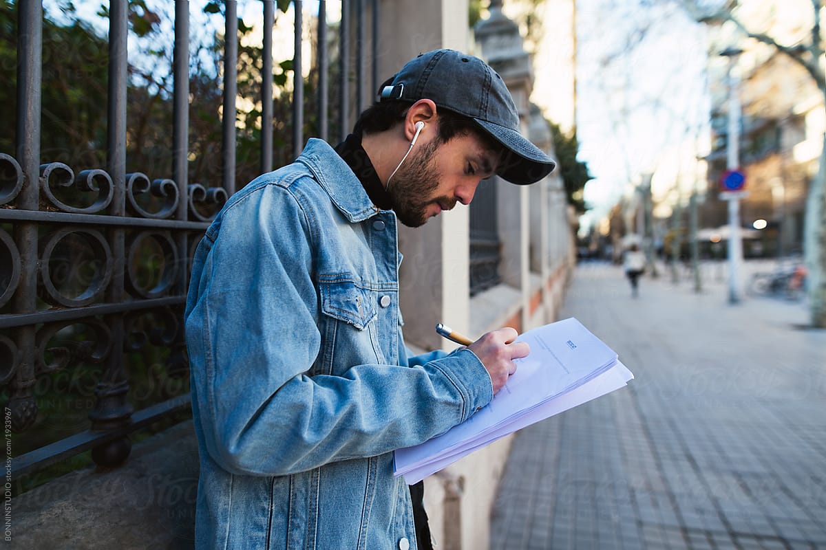 Actor reading script on the street.