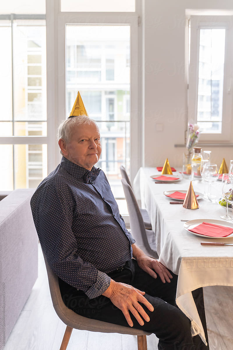 Elegant Senior Man Sitting At Celebration Table