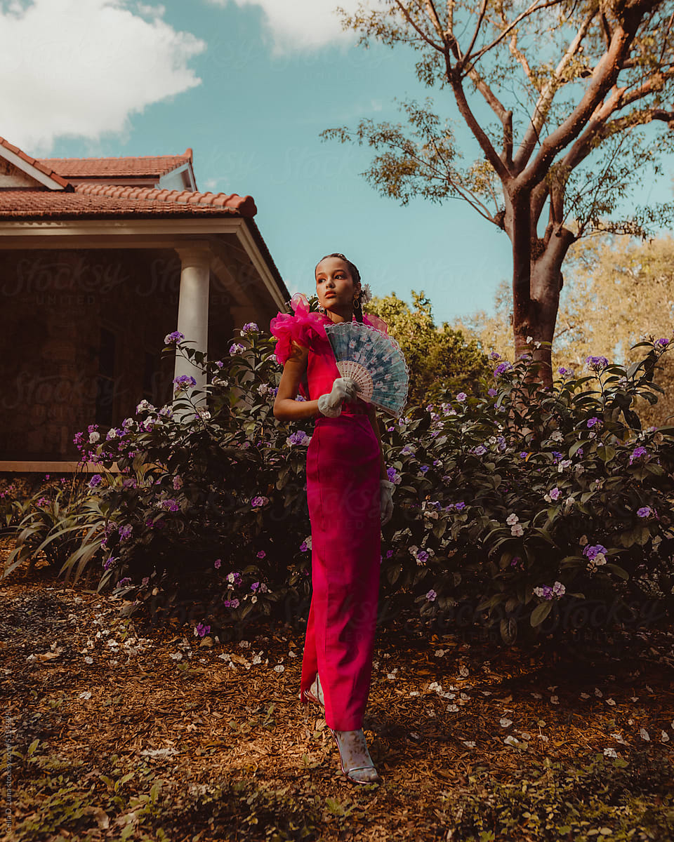 Elegant young afro latinx woman standing in a garden