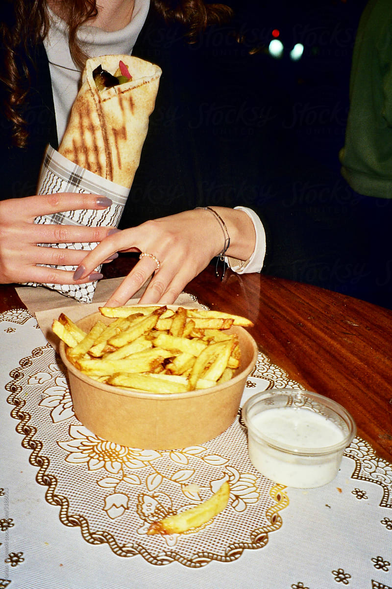 Woman eating fries and falafel