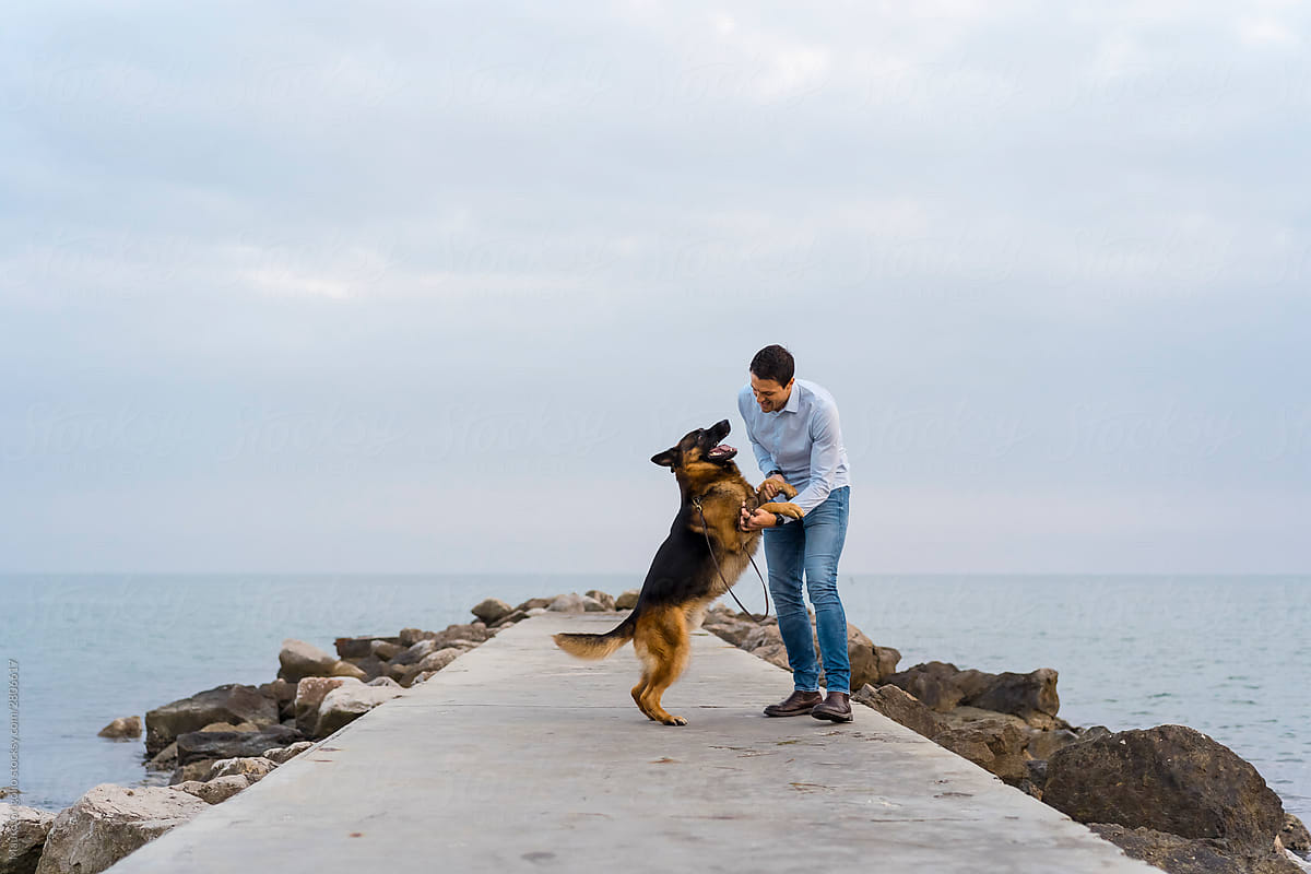 Man having fun in a jetty with his dog