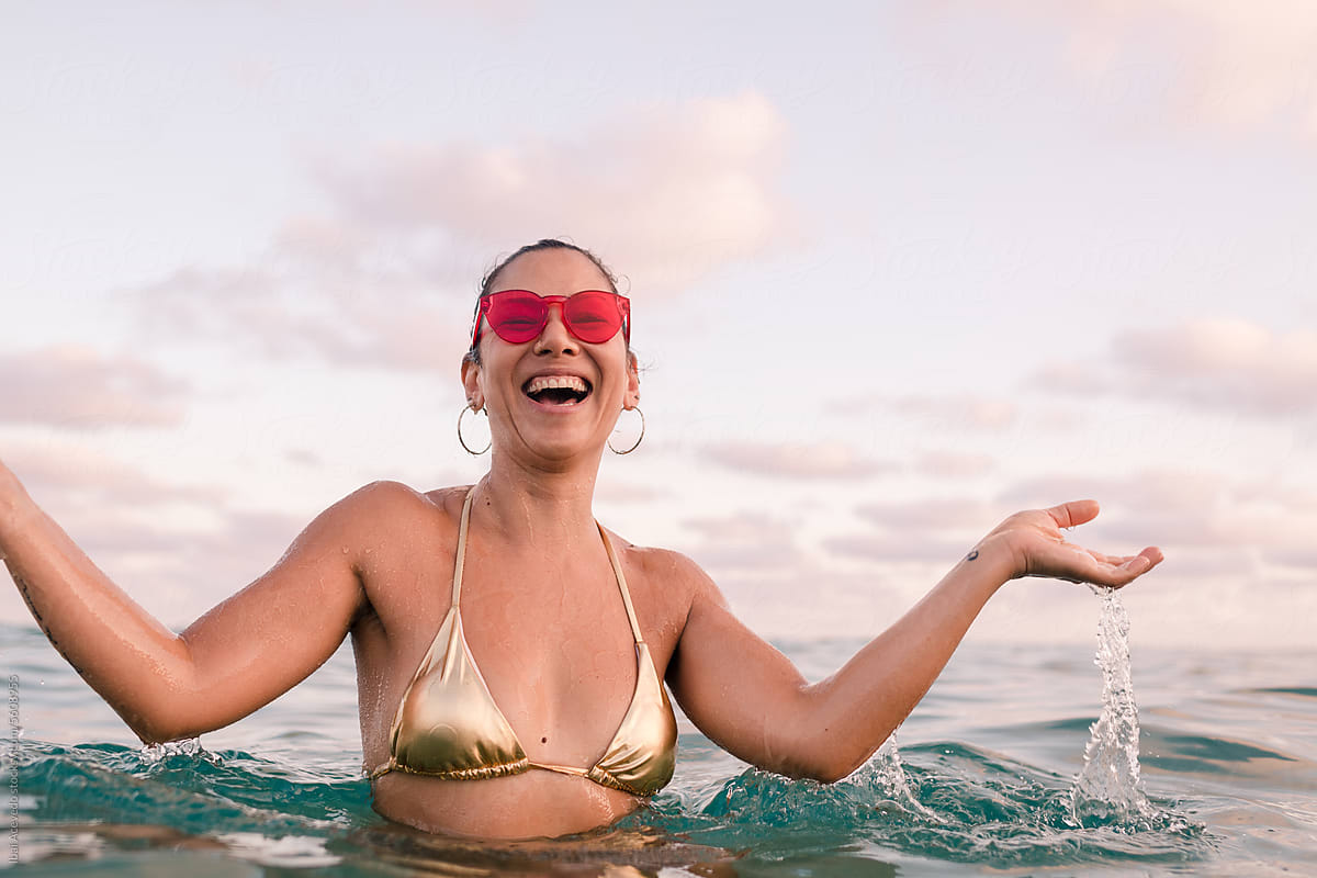 Cheerful stylish woman having fun in the sea
