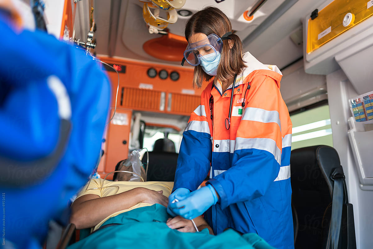 Paramedic woman working in ambulance