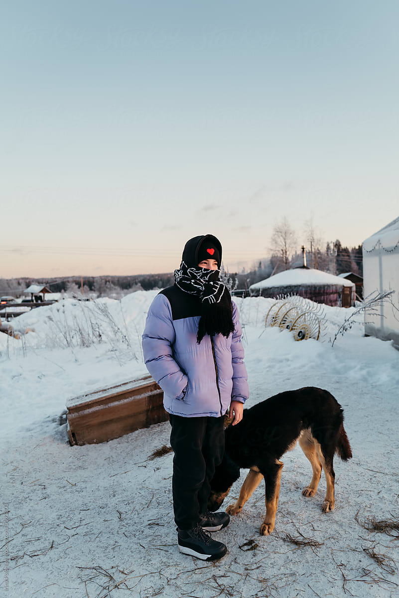 Boy with dog outdoor in winter.