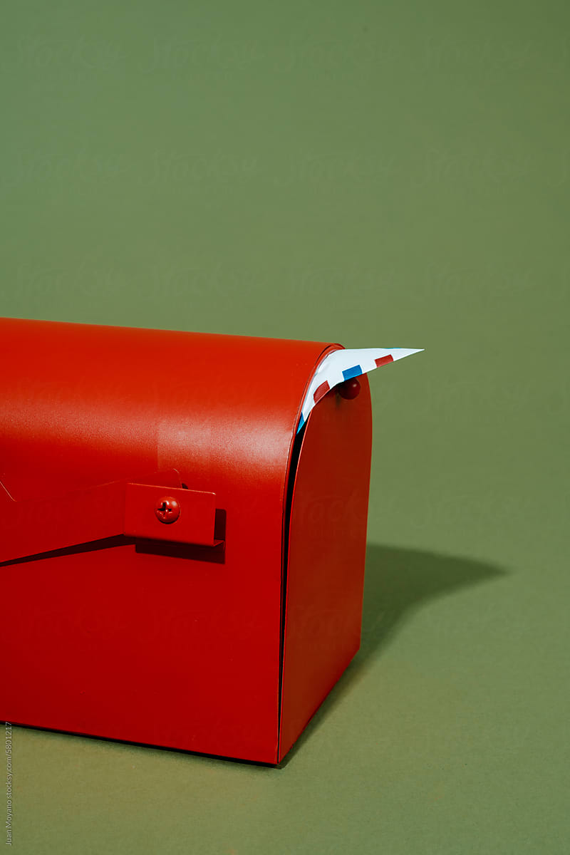 airmail letter in a red mailbox