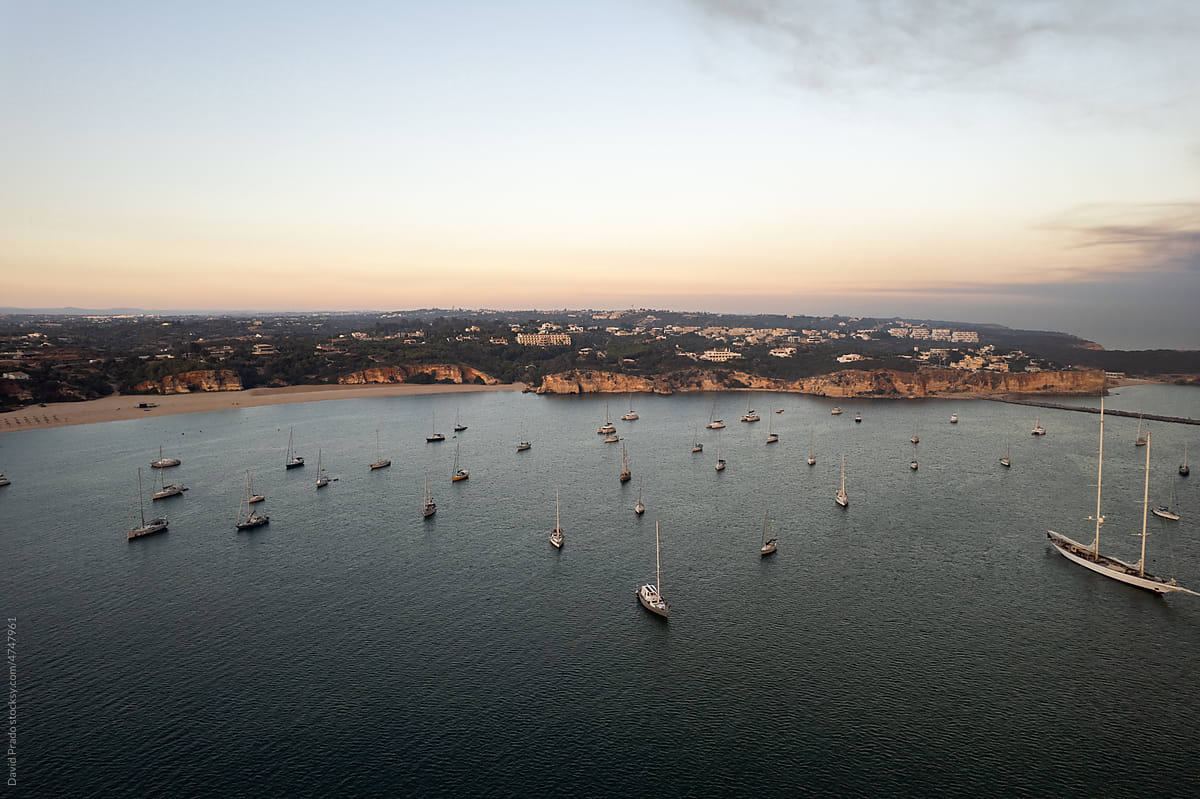 Yachts floating on sea under sundown sky in Portugal