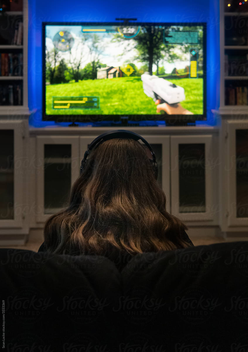Girl Plays Modern Shooter Video Game On TV
