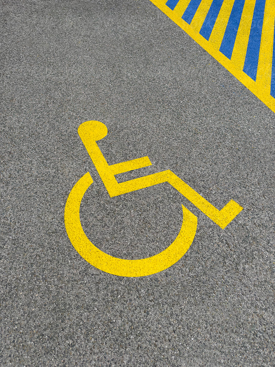 yellow marked parking spot for the disabled on the pavement