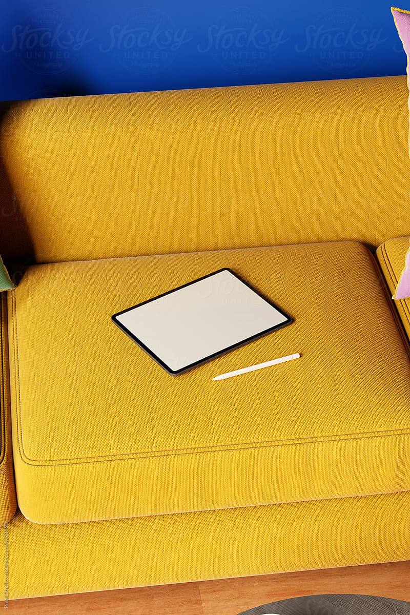 Tablet with empty blank screen on sofa in apartment. Mock up