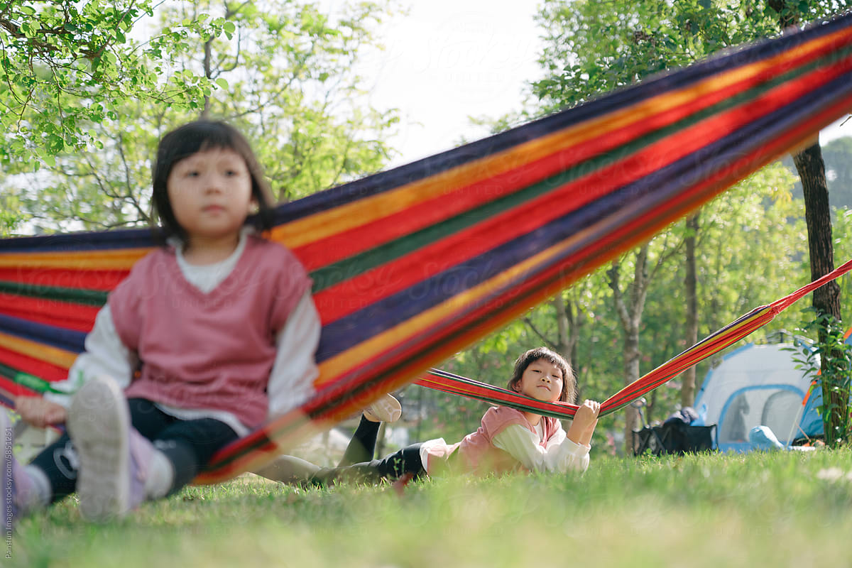 Asian kid hanging out in hammock